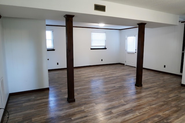 basement featuring dark hardwood / wood-style floors and a healthy amount of sunlight