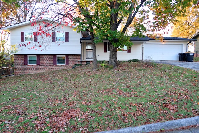 view of front of property with a front yard and a garage