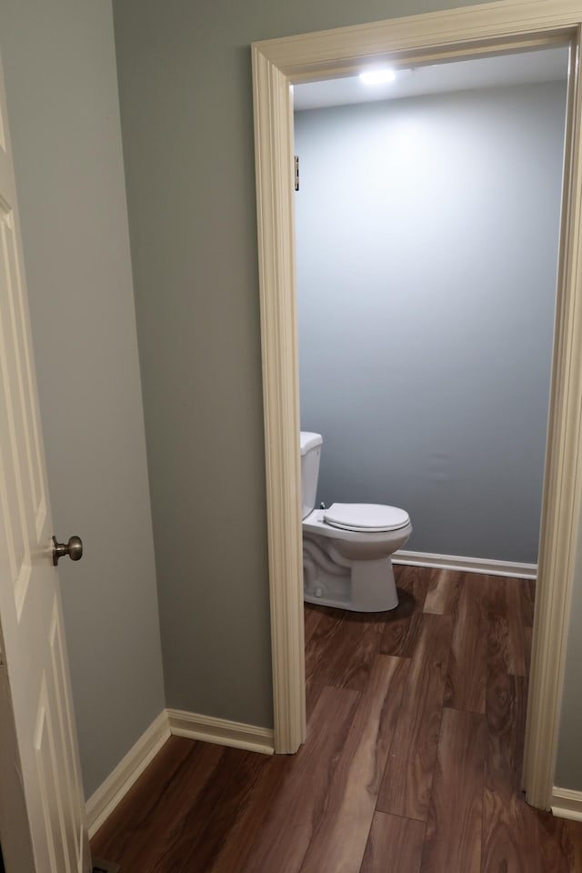 bathroom featuring hardwood / wood-style floors and toilet