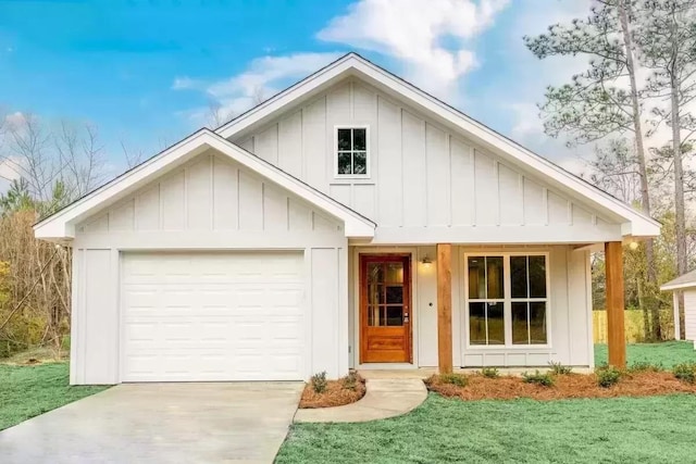 view of front of home with a front yard and a garage