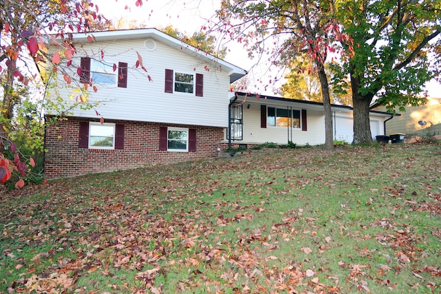 view of front facade with a front yard and a garage