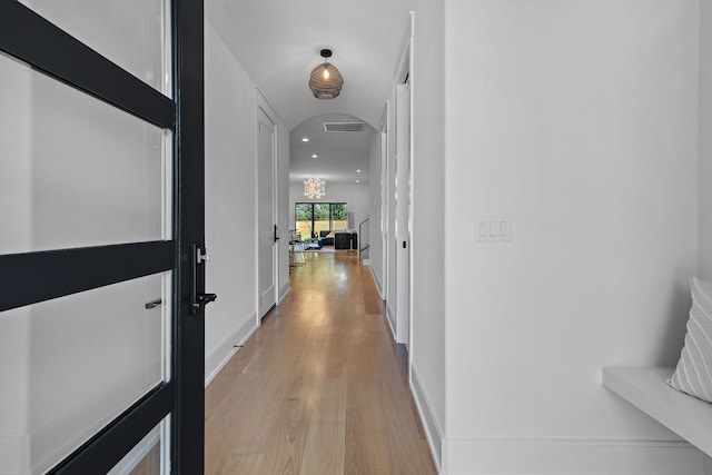 hallway with light hardwood / wood-style floors