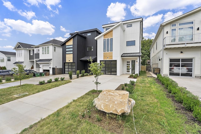 view of property with a garage and a front lawn