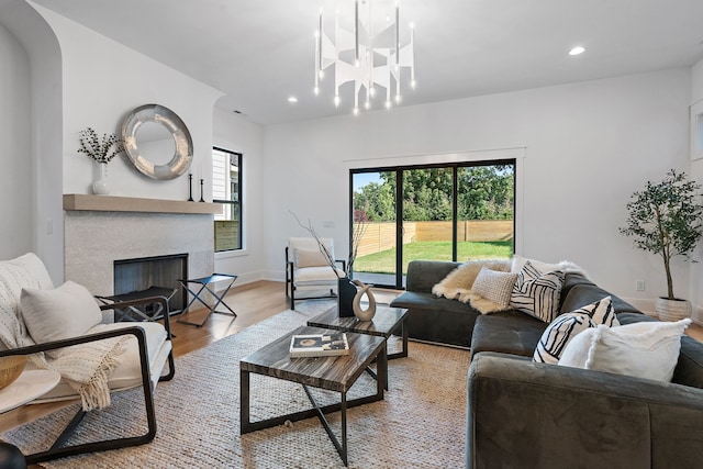 living room with light hardwood / wood-style floors and an inviting chandelier