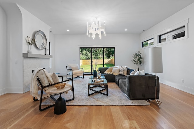 living room featuring a chandelier and light hardwood / wood-style floors