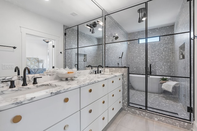 bathroom featuring tile patterned floors, vanity, and a shower with shower door