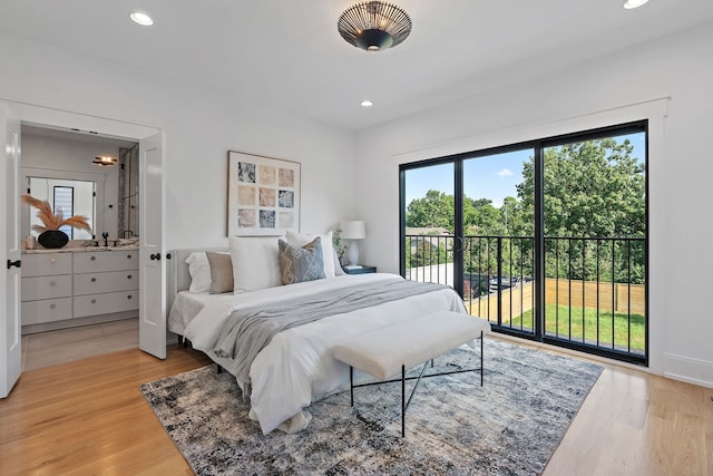 bedroom with access to exterior and light hardwood / wood-style flooring