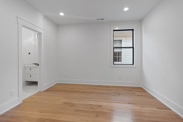 unfurnished room with light hardwood / wood-style floors