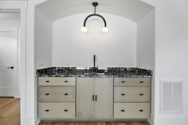 bathroom with hardwood / wood-style flooring and sink