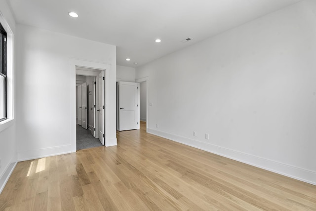 empty room with light hardwood / wood-style floors