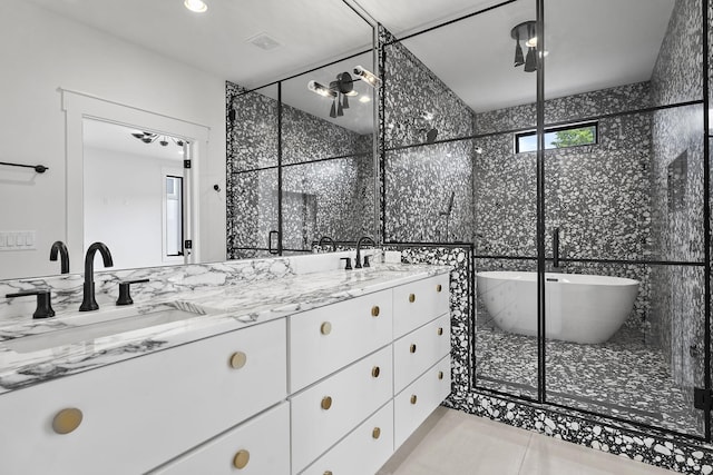 bathroom with vanity, shower with separate bathtub, and tile patterned flooring