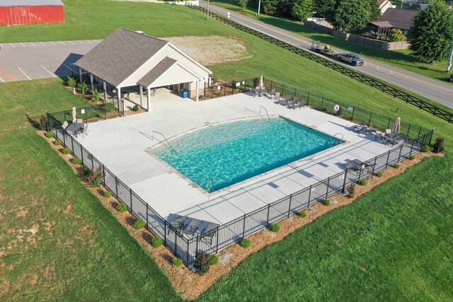 view of swimming pool featuring a yard and a patio