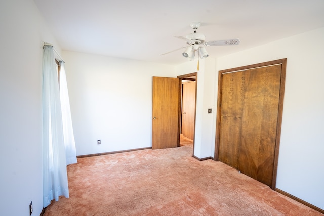 unfurnished bedroom with ceiling fan, a closet, and carpet floors