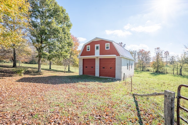 view of outdoor structure with a yard and a garage