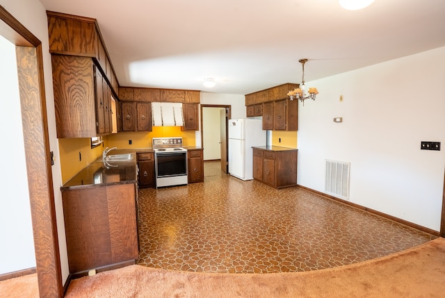 kitchen with a notable chandelier, white appliances, sink, and decorative light fixtures