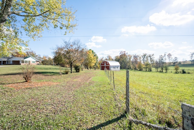 view of yard with an outbuilding and a rural view