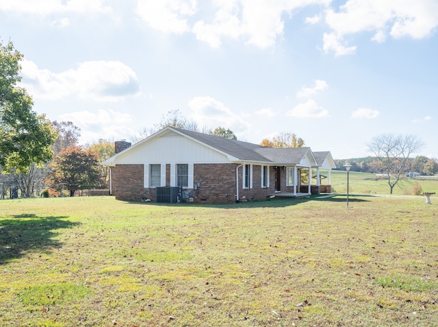 single story home featuring central AC and a front lawn