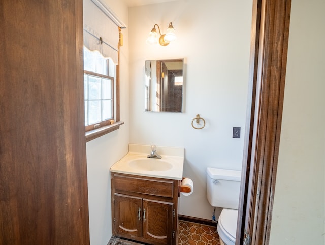 bathroom with tile patterned flooring, vanity, and toilet