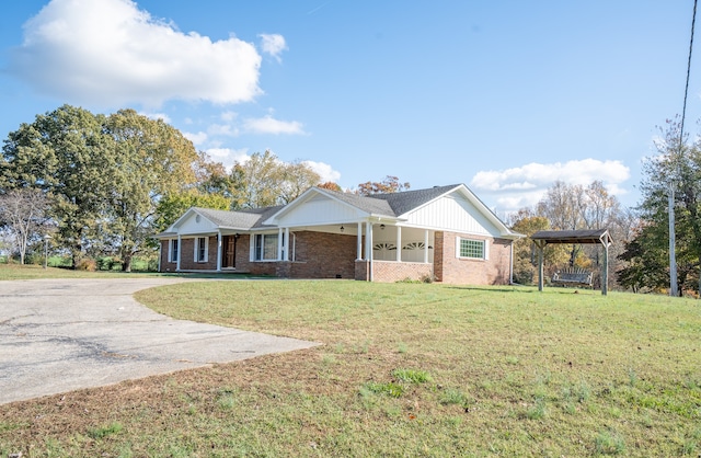 ranch-style home featuring a porch and a front lawn