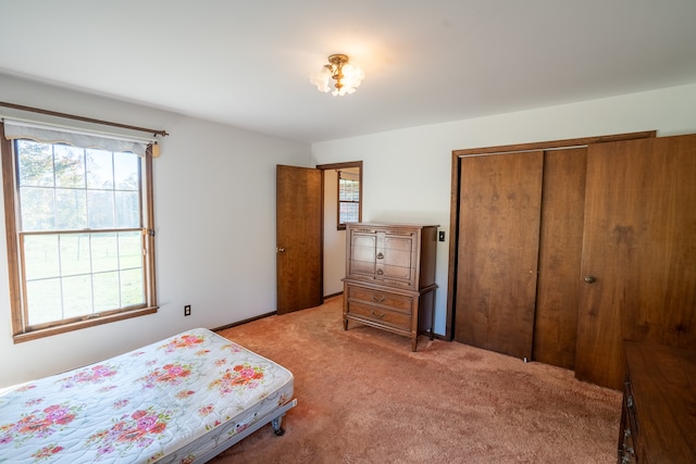 bedroom with light carpet and a closet