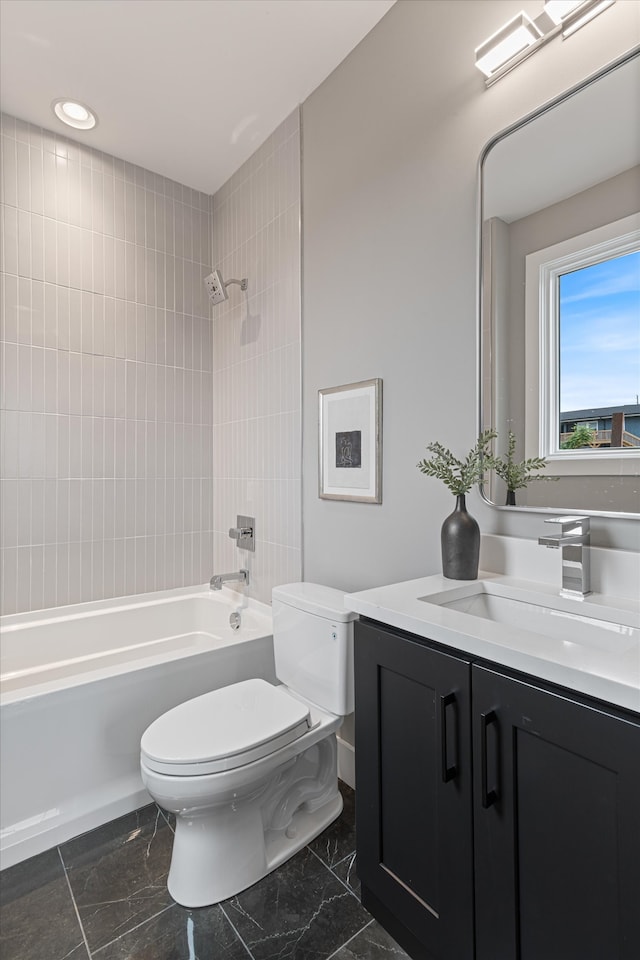 full bathroom featuring tiled shower / bath combo, toilet, and vanity