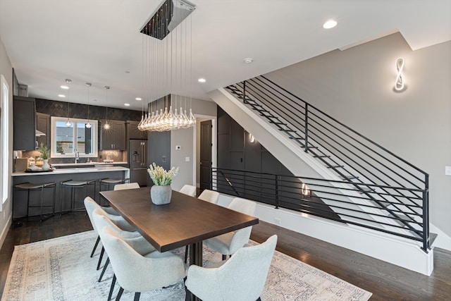 dining space featuring sink and dark wood-type flooring