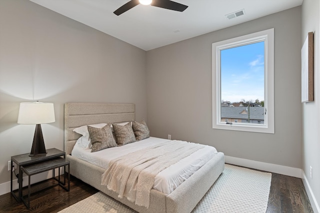 bedroom with ceiling fan and dark wood-type flooring