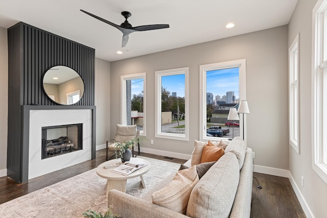 living room with dark hardwood / wood-style flooring and ceiling fan