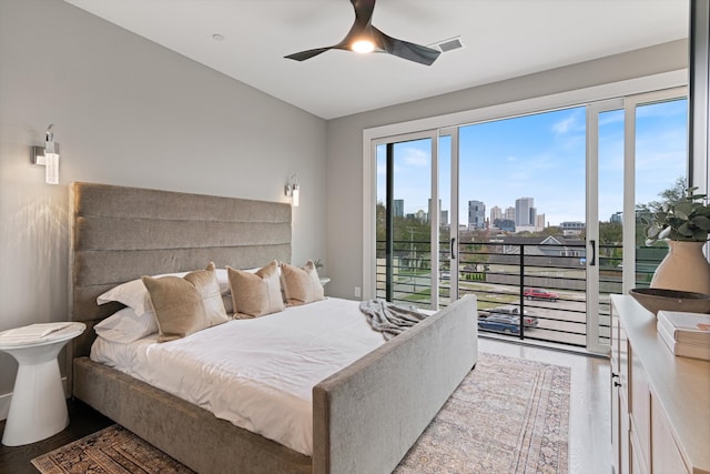 bedroom with access to exterior, ceiling fan, and hardwood / wood-style flooring