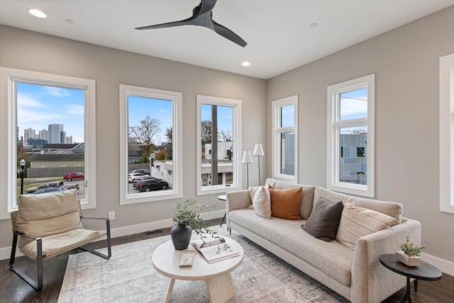 living room featuring dark hardwood / wood-style floors, a healthy amount of sunlight, and ceiling fan