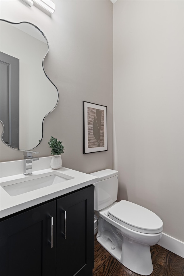 bathroom featuring hardwood / wood-style flooring, vanity, and toilet