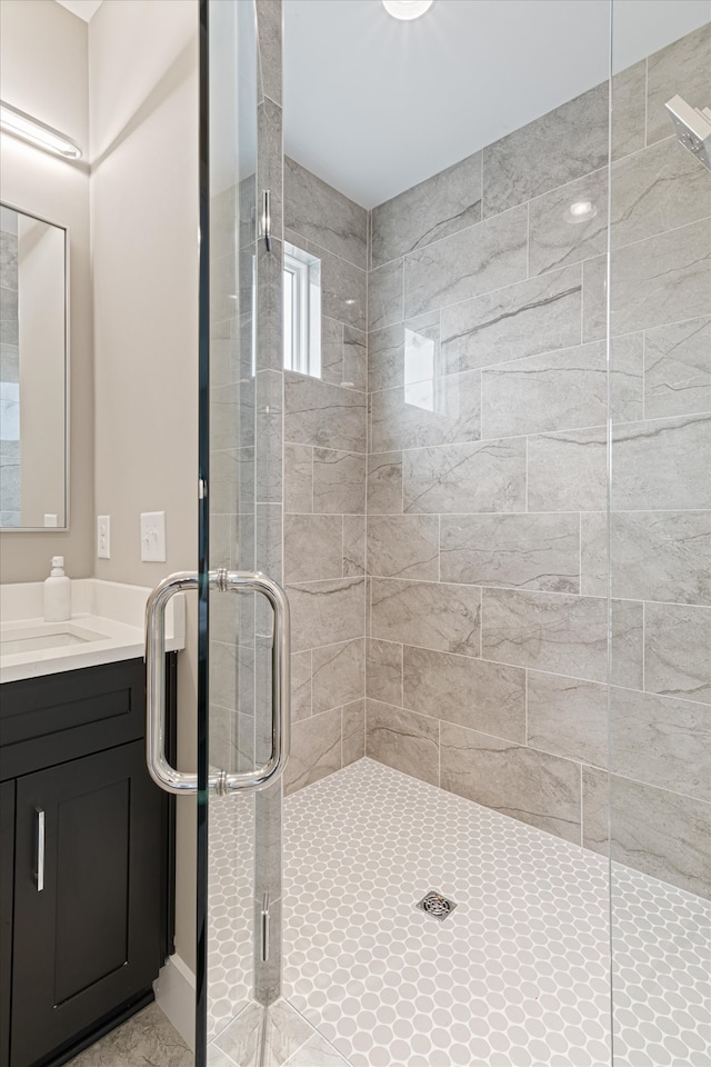 bathroom featuring vanity and a shower with shower door