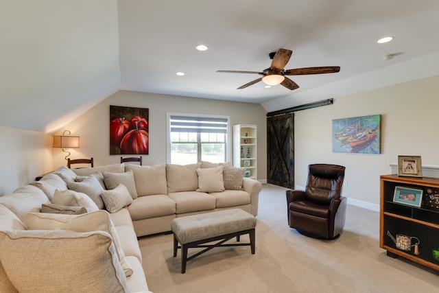 carpeted living room with ceiling fan and lofted ceiling