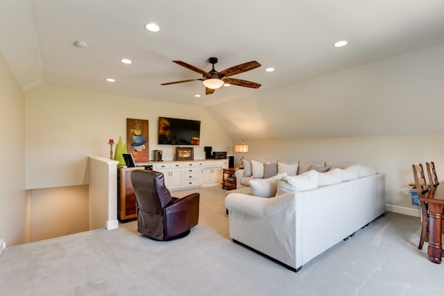 living room with light carpet, ceiling fan, and vaulted ceiling