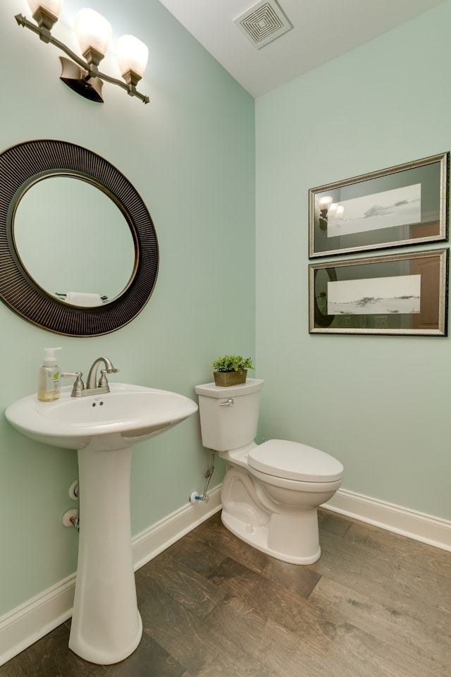 bathroom featuring hardwood / wood-style floors, toilet, and sink