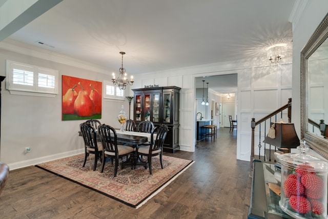 dining room featuring ornamental molding, dark wood-type flooring, and a chandelier