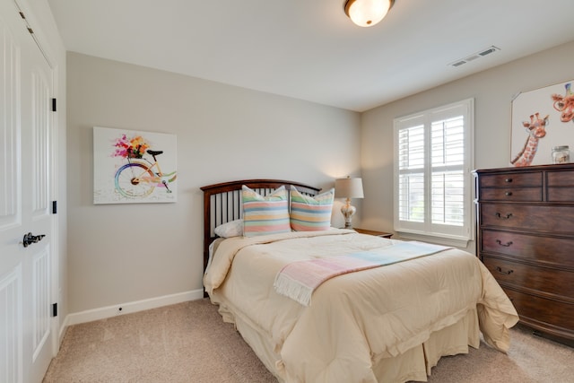 bedroom featuring light colored carpet