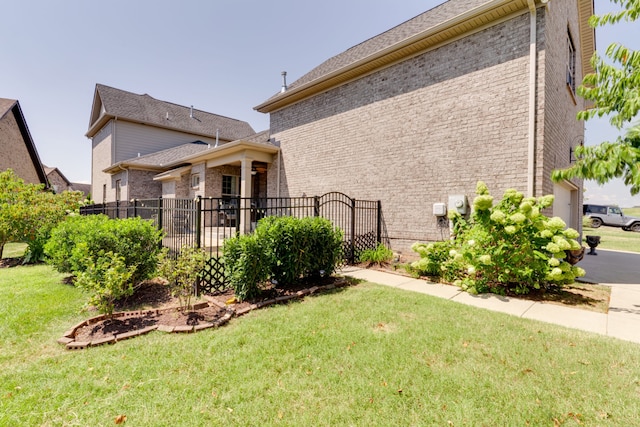 view of side of home with a yard