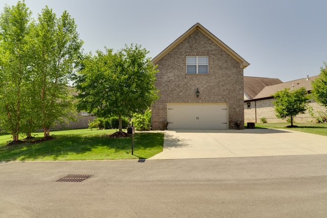 view of front of house with a garage and a front lawn