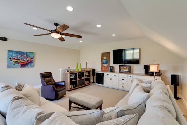 living room featuring light colored carpet, ceiling fan, and lofted ceiling