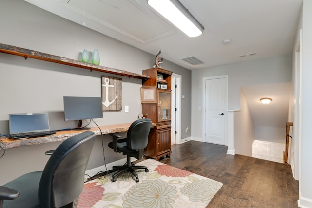 office space with built in desk and dark wood-type flooring