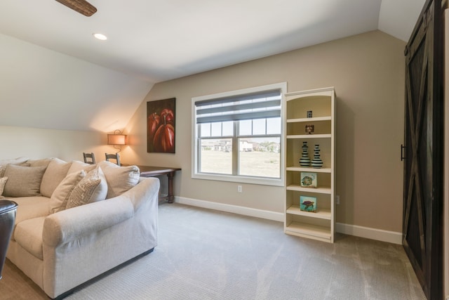 living area featuring light carpet and vaulted ceiling