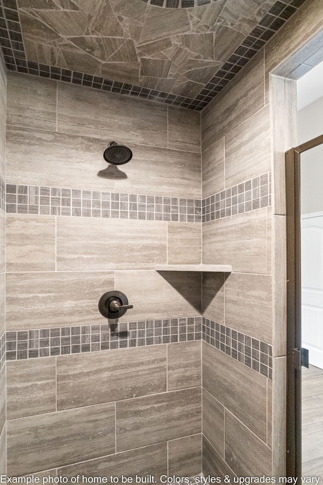 interior details featuring a tile shower