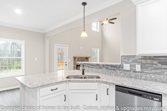 kitchen with light stone countertops, sink, stainless steel dishwasher, and white cabinets