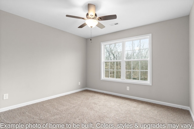 carpeted spare room with ceiling fan