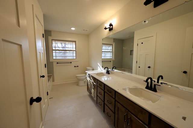 bathroom with walk in shower, tile patterned floors, vanity, and toilet