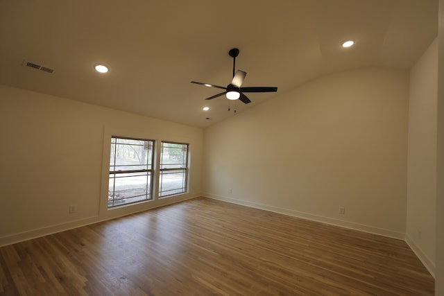 empty room featuring dark hardwood / wood-style floors, ceiling fan, and lofted ceiling