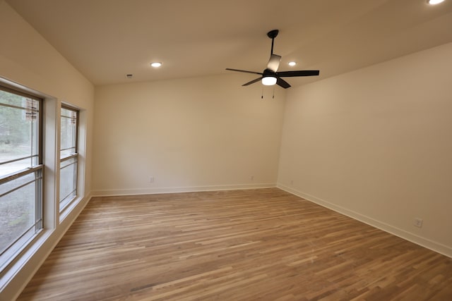 spare room with ceiling fan, light hardwood / wood-style flooring, and lofted ceiling