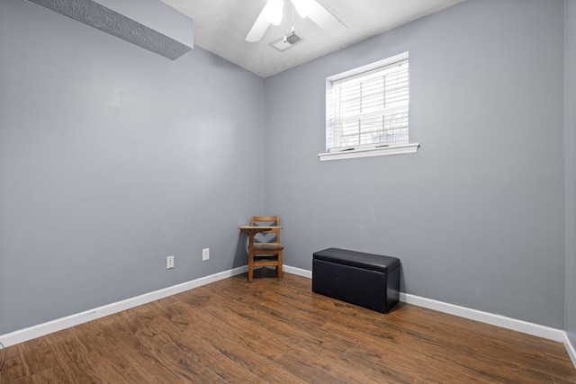 empty room featuring a textured ceiling, dark hardwood / wood-style flooring, and ceiling fan