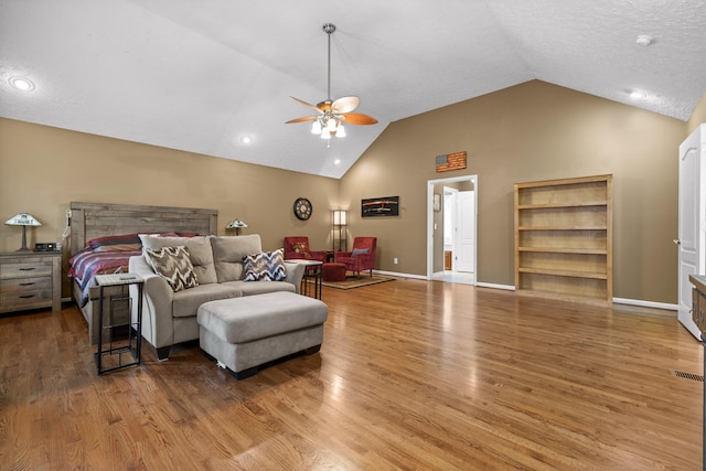 bedroom with hardwood / wood-style flooring, ceiling fan, and high vaulted ceiling